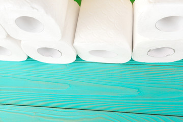 Toilet paper rolls on turquoise bright background