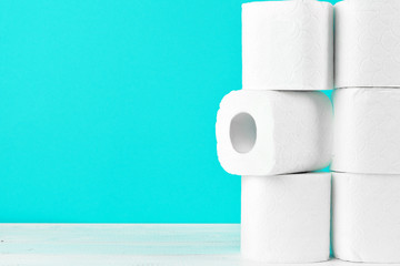 Toilet paper rolls on turquoise bright background