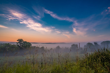Morning fog in a ravine at sunrise