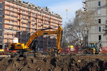 new building construction site and excavators