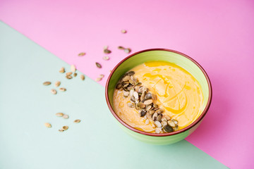 homemade Warm pumpkin soup with pumpkin seeds and cream