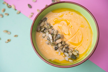 homemade Warm pumpkin soup with pumpkin seeds and cream
