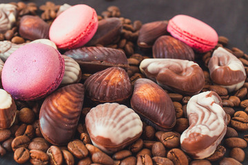  Chocolate lies on the coffee beans. Macaroon cookies and chocolate shells
