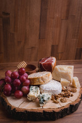 cheese plate on a wooden table. rustic