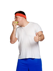 Fat man eating a apple isolated on white background