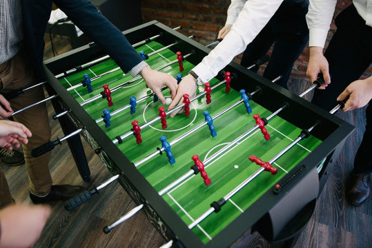 A group of people playing table football