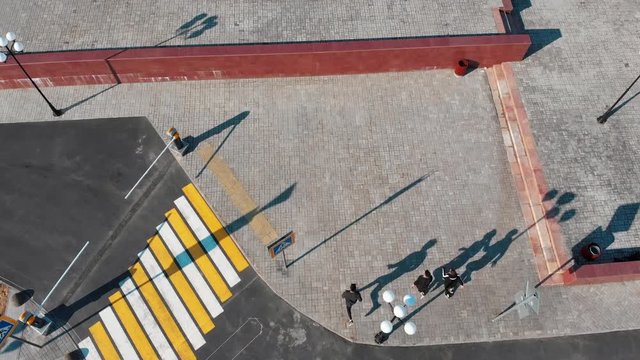 Three athletic young men running on the road and about to performing tricks.