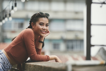 Asian happy woman standing outdoors