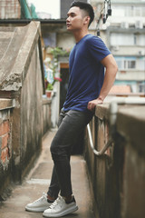 Fototapeta na wymiar Asian young man standing in the city