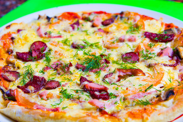 hot tasty fresh pizza on a plate close-up. green background