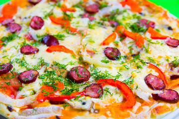 hot tasty fresh pizza on a plate close-up. green background