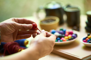 Woman making handmade beads