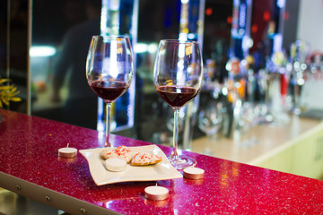 two glasses of wine and heart-shaped cookies. Valentine's Day