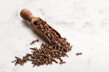 Spice cloves on marble background with copy space