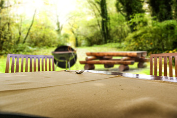 Desk of free space and grill background in garden. 