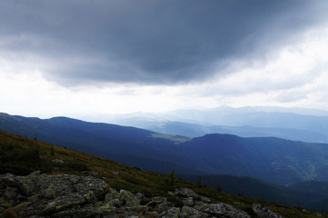 Naklejka premium Mountain landscape with green grass against the sky. Panoramic view of the cliffs without people. Wildlife on hills and altitude.