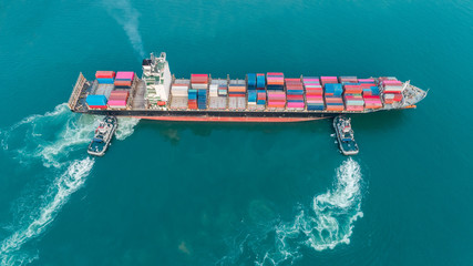 Aerial top view tug boat drag container ship to sea port for logistics, import export, shipping or...