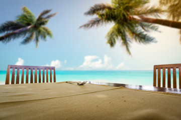 table background of free space for your decoration and summer background of beach sea and palms 