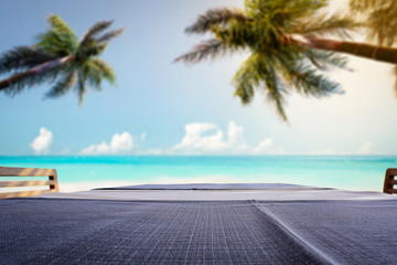 table background of free space for your decoration and summer background of beach sea and palms 