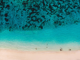 Top view of beautiful sand beach with turquoise ocean water, aerial shot