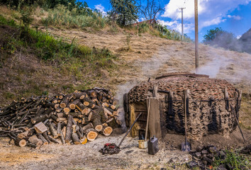 Traditional charcoal pile covered with clay, used for production of charcoal in Serbia