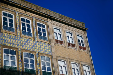 Fototapeta na wymiar old colorful building and facades against the blue sky in the historic center of Porto, Portugal
