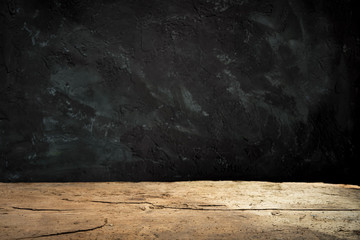 cement floor in dark room with spot light. black background.
