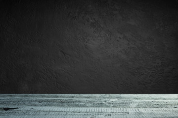 cement floor in dark room with spot light. black background.