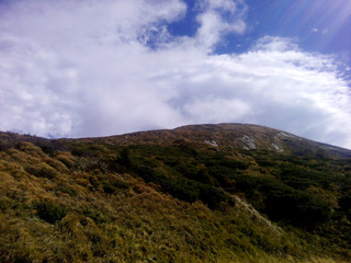 Obraz na płótnie Canvas Mountain landscape green hills against the blue sky.
