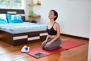 Woman relaxing during yoga exercise