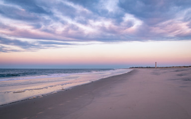 Cape May, NJ, beach and ocean provides beautiful calming sunrise in violet hues on an early spring morning