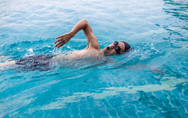 Young man Professional  watersport ,which Slim sportsman swimming in a pool.