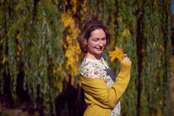 Pretty woman portrait in autumn park