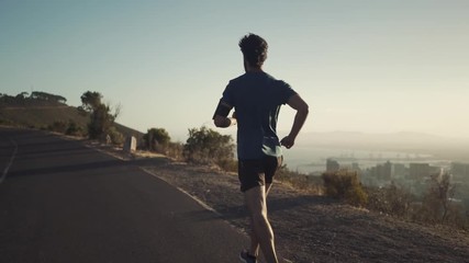 Athletic young man running on the road