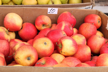Fresh fruit in boxes. Market on the street. Red  apples. 