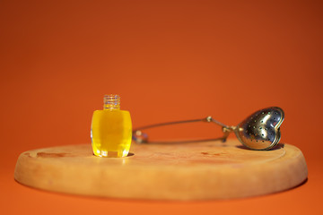 Bottle of honey on an orange background.
