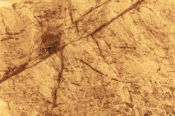 Vintage yellow background. Rough painted wall of aspen gold color. Imperfect plane of golden colored. Uneven old decorative toned backdrop of yellow tint. Texture of gold hue. Ornamental stony surface