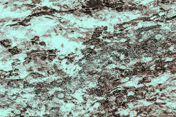 Vintage cyan background. Rough painted wall of hazel color. Imperfect plane of brown colored. Uneven old decorative toned backdrop of blue tint. Texture of azure hue. Ornamental stony surface.