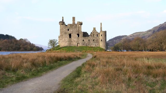  Historic Castle ruins on a lake morning in Scotland - Kilchurn Castle is a ruined structure on a rocky peninsula at the northeastern end of Loch Awe, in Argyll and Bute, Scotland. 4K VIDEO