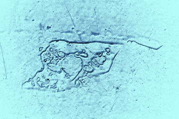 Vintage blue background. Rough painted wall of sapphire color. Imperfect plane of blue colored. Uneven old decorative toned backdrop of cyan tint. Texture of sapphirine hue. Ornamental stony surface.