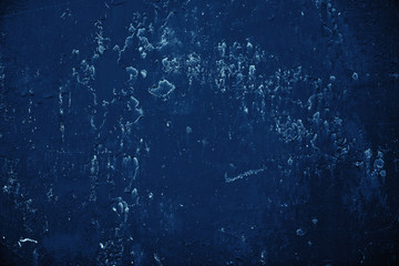 Vintage blue background. Rough painted wall of sapphire color. Imperfect plane of blue colored. Uneven old decorative toned backdrop of cyan tint. Texture of sapphirine hue. Ornamental stony surface.