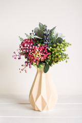 Various artificial flowers, bouquets in vases, succulents