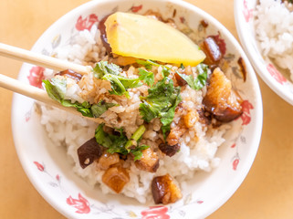 Braised pork over rice - Taiwan famous traditional street food delicacy. Soy-stewed pork on rice. Travel design concept. Top view,copy space,close up
