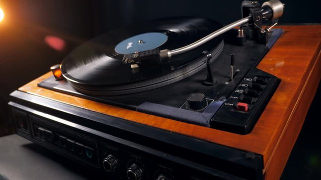 Vinyl disc is getting taken off from the turntable