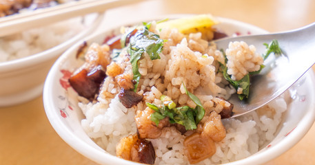 Braised pork over rice - Taiwan famous traditional street food delicacy. Soy-stewed pork on rice. Travel design concept. Top view,copy space,close up