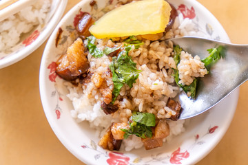 Braised pork over rice - Taiwan famous traditional street food delicacy. Soy-stewed pork on rice. Travel design concept. Top view,copy space,close up