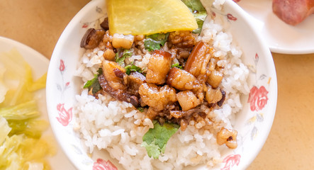 Braised pork over rice - Taiwan famous traditional street food delicacy. Soy-stewed pork on rice. Travel design concept. Top view,copy space,close up