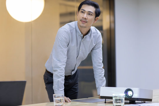 Business people looking at the slides  in board room