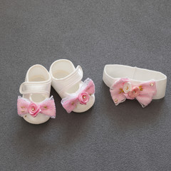 a pair of shoes with headband for a little girl