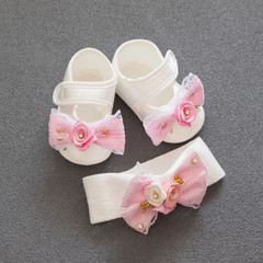 a pair of shoes with headband for a little girl